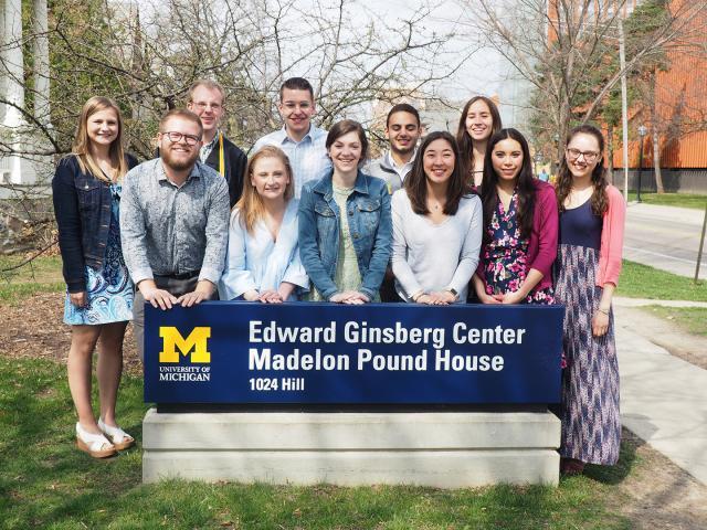 Ginsberg members standing in front of a sign reading Edward Ginsberg Center Madelon Pound House