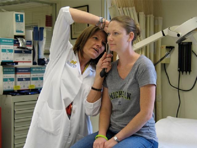 A doctor checking a patient's ear